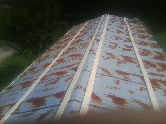 Rusted metal roof panels with new wood purlins before replacement — Storm Damage Roof Repair in Littlerock by Roofing Brothers
