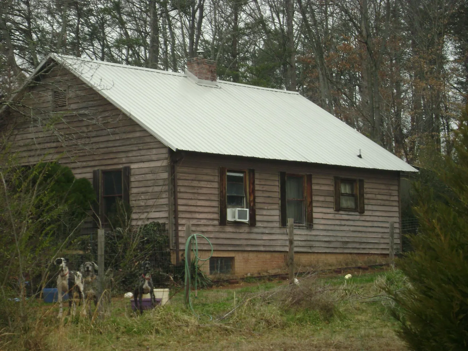 White metal roof on an old wood sided farmhouse, from a Asphalt Shingle Roof Repair job in Littlerock